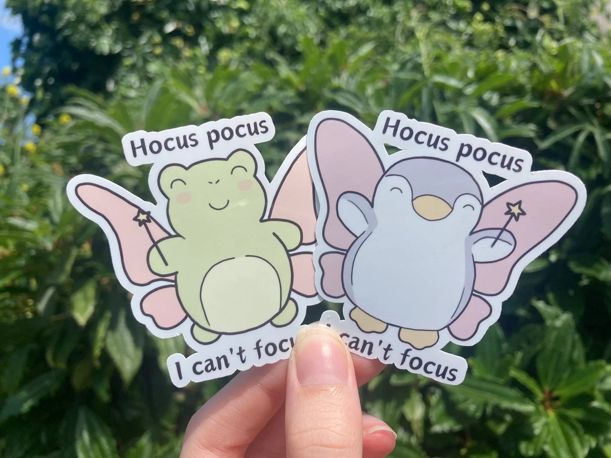 Relatable ADHD frog and penguin sticker with the text "Hocus pocus, I can't focus", handmade by Neurodiversetea