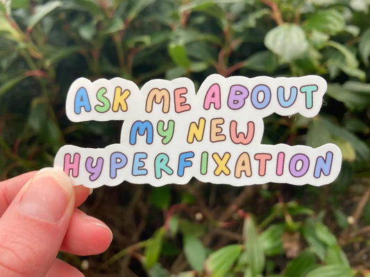 "Ask me about my new hyperfixation" rainbow font ADHD sticker, handmade by Neurodiversetea